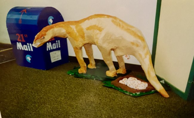 Paper mache' dinosaur laying eggs. Elementary school project.